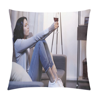 Personality  Depressed Woman In Beige Sweater And Jeans Sitting On Sofa And Holding Glass Of Red Wine In Outstretched Hands At Home Pillow Covers