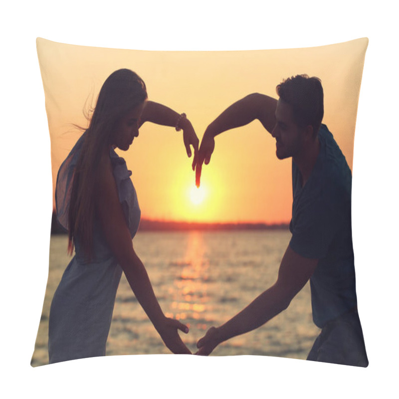 Personality  Young couple in love holding hands in the shape of a large heart on the beach at sunset pillow covers