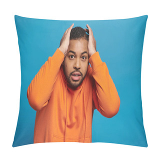 Personality  Worried African American Young Man In Orange Outfit Holding To Head With Hands On Blue Background Pillow Covers