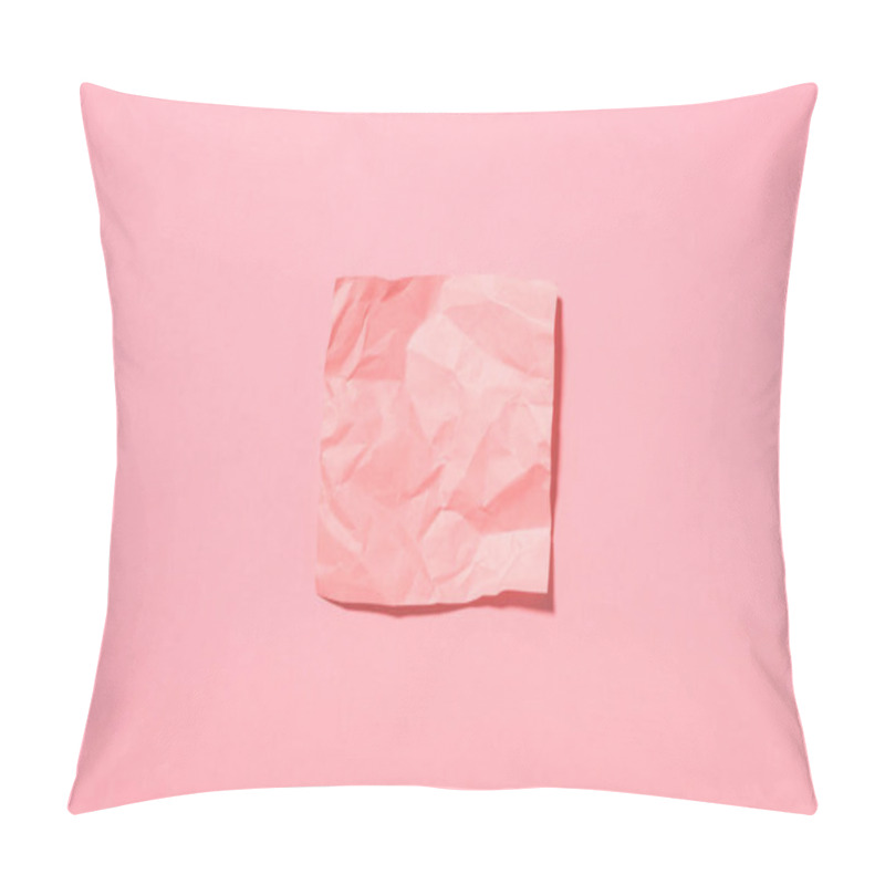 Personality  view from above of crumpled empty stick it note on pink pillow covers