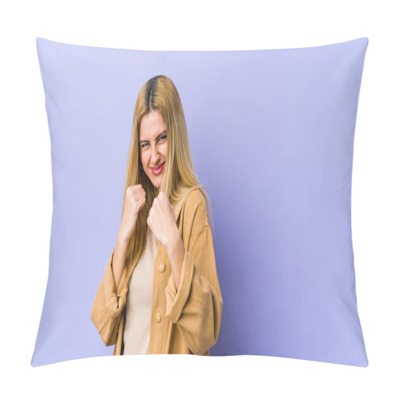 Personality  Young blonde caucasian woman showing fist to camera, aggressive facial expression. pillow covers