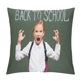 Personality  Selective Focus Of Angry Schoolgirl Showing Scaring Gesture Near Chalkboard With Back To School Lettering Pillow Covers