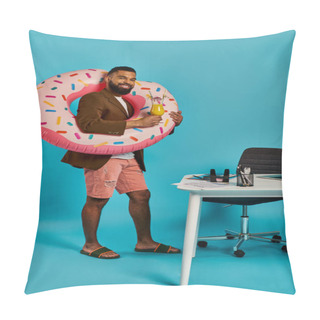 Personality  A Man With A Playful Smile Holds A Large Inflatable Donut In Front Of A Cluttered Desk, Creating A Whimsical And Surreal Scene. Pillow Covers
