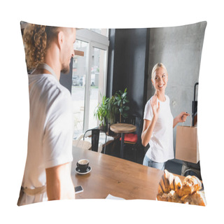 Personality  Cheerful Blonde Woman Holding Paper Bag And Waiving Hand To Barista On Blurred Foreground Pillow Covers