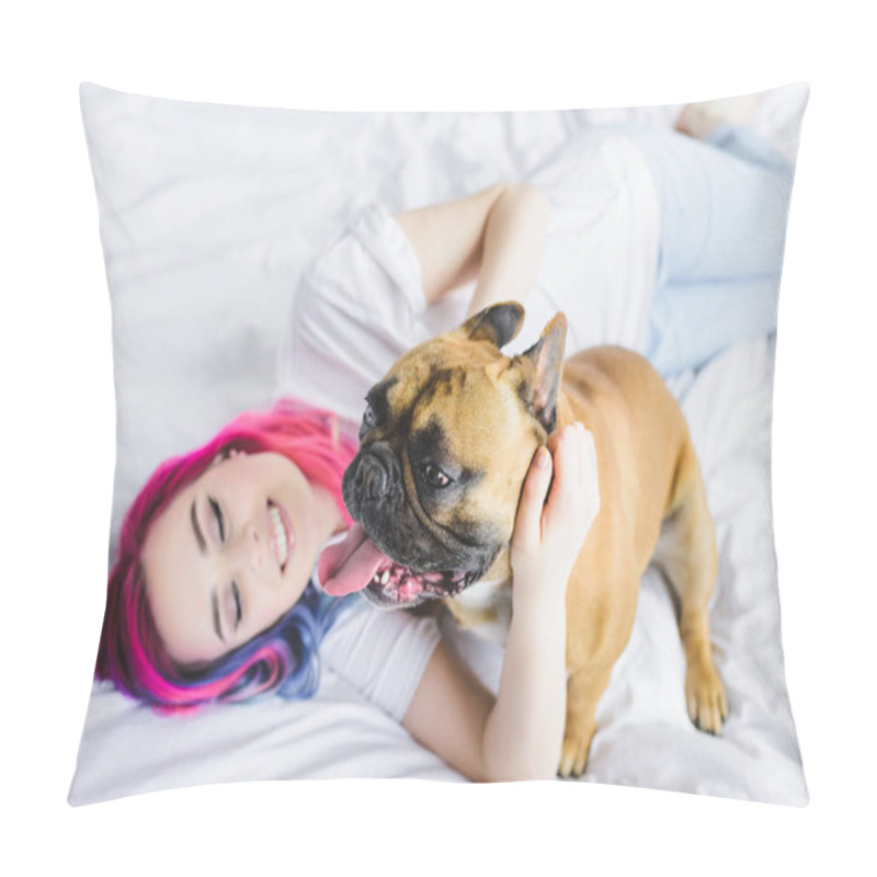 Personality  selective focus of french bulldog and happy girl with colorful hair laying with in bed  pillow covers