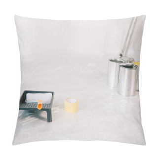 Personality  Cans With Paint, Paint Roller In Roller Tray And Masking Tape On White Floor Covered With Cellophane Pillow Covers