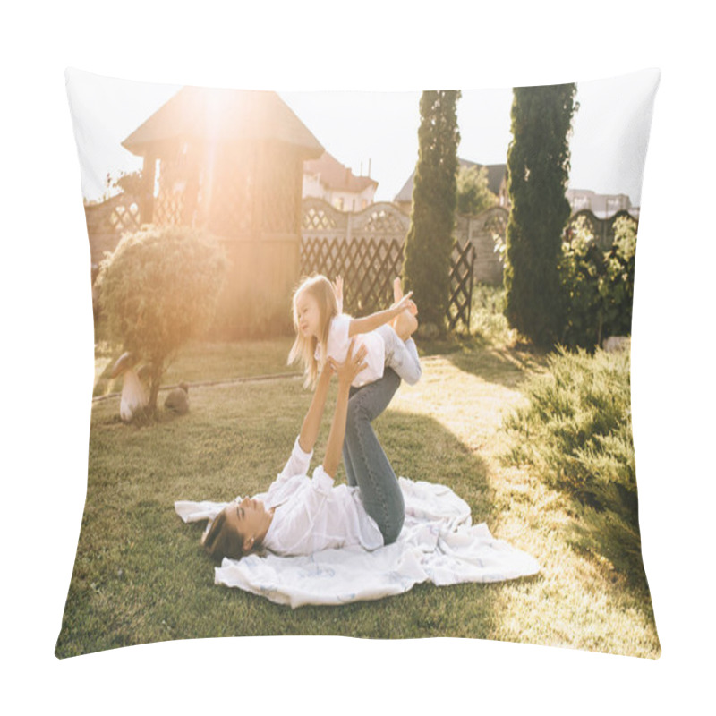 Personality  mother and cute little daughter having fun together on backyard pillow covers