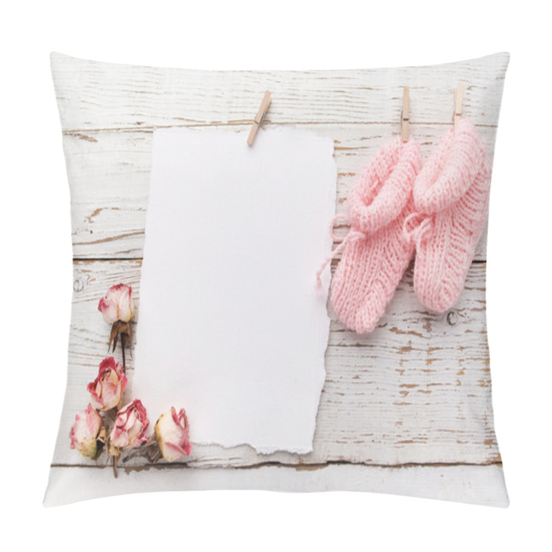 Personality  pink babys booties. Small girls sock and blank card on white wooden background pillow covers