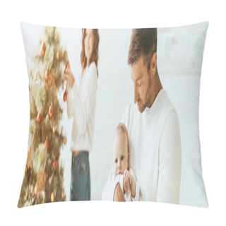 Personality  Panoramic Shot Of Woman Decorating Christmas Tree And Looking At Happy Husband Holding Infant Pillow Covers