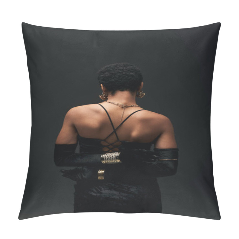 Personality  Back view of elegant and short haired african american woman in gloves, dress and modern accessories standing isolated on black, high fashion and evening look, feminine pillow covers