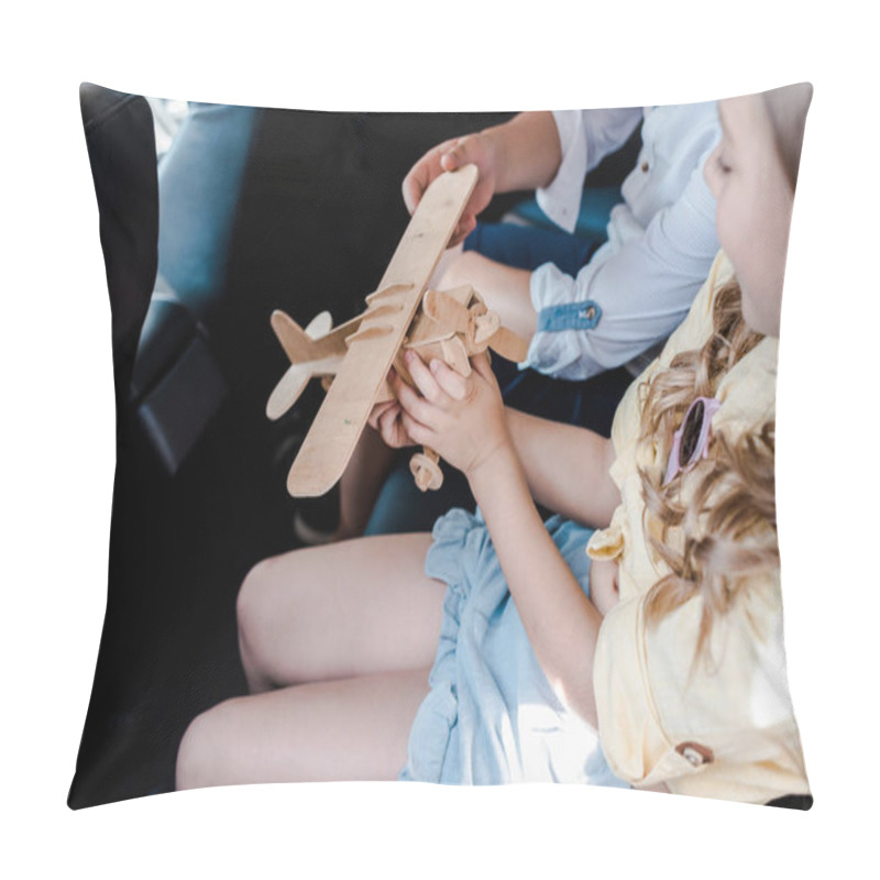 Personality  cropped view of children playing with wooden biplane in car  pillow covers