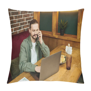 Personality  A Man Sits At A Table, Engaged In Conversation On A Cell Phone In A Trendy Modern Cafe Setting. Pillow Covers