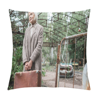 Personality  PRIPYAT, UKRAINE - AUGUST 15, 2019: Selective Focus Of Senior Woman Holding Suitcase In Amusement Park  Pillow Covers