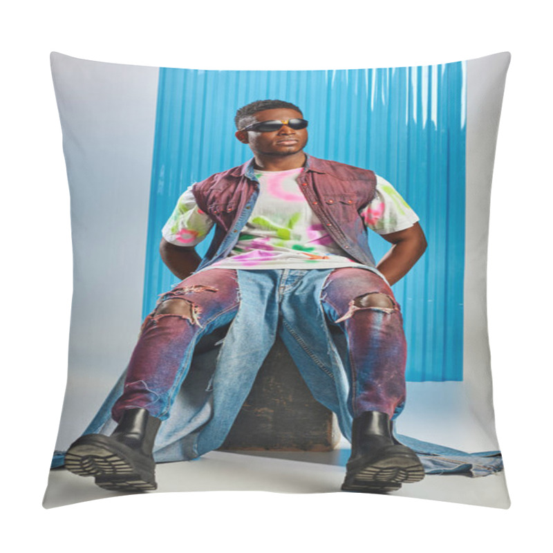 Personality  Full Length Of Stylish African American Model In Sunglasses, Denim Vest And Ripped Jeans Sitting On Stone On Grey With Blue Polycarbonate Sheet At Background, Fashion Shoot, Sustainable Fashion  Pillow Covers