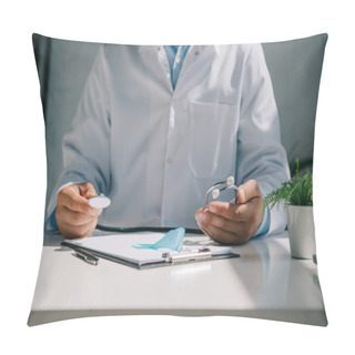 Personality  Cropped View Of Doctor Sitting At Desk And Holding Stethoscope Near Blue Awareness Ribbon Pillow Covers