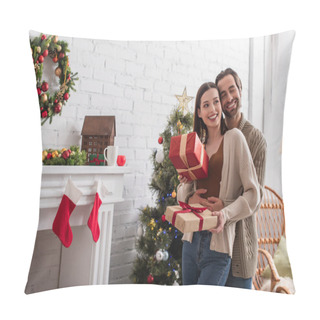 Personality  Happy Man Embracing Wife Holding Gift Boxes Near Christmas Tree And Decorated Fireplace Pillow Covers