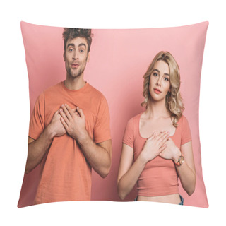Personality  Tricky Young Man And Serious, Honest Girl Holding Hands On Chest While Looking At Camera On Pink Background Pillow Covers