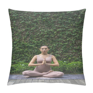 Personality  Attractive Young Woman Meditating In Lotus Pose With Namaste Mudra In Front Of Wall Covered With Green Leaves Pillow Covers