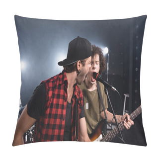 Personality  KYIV, UKRAINE - AUGUST 25, 2020: Rock Band Musicians Shouting In Microphone With Blurred Drummer On Background Pillow Covers