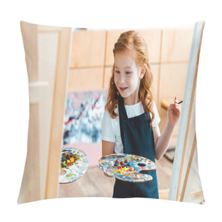 Personality  Selective Focus Of Redhead Kid Looking At Easel While Holding Palette  Pillow Covers