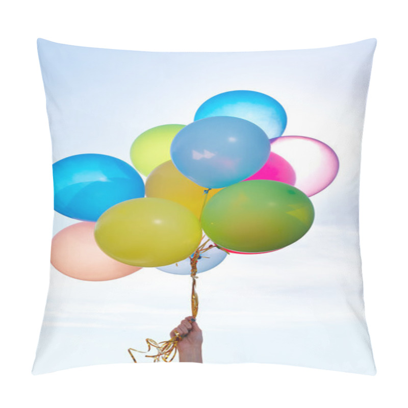 Personality  Hand holding bunch of colorful balloons in blue sky pillow covers