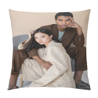 Personality  Fashionable Interracial Models In Trendy Pantsuits Looking At Camera Near Armchair On Beige Background Pillow Covers