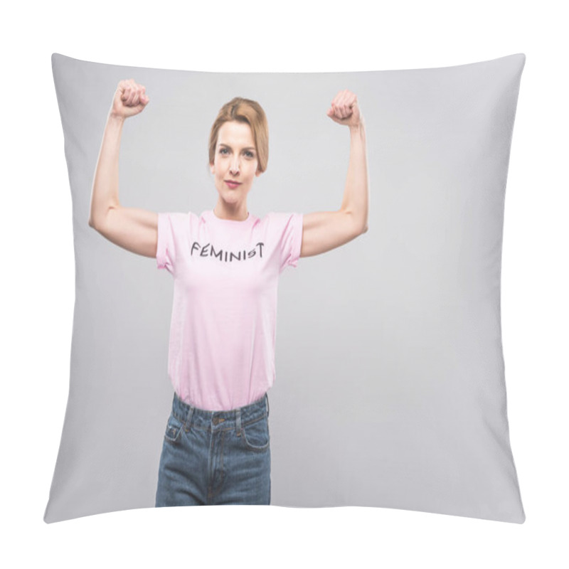 Personality  strong woman in pink feminist t-shirt showing muscles on arms, isolated on grey pillow covers