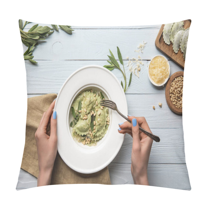 Personality  cropped view of woman eating green ravioli with pine nuts and sage near grated cheese on white wooden table  pillow covers
