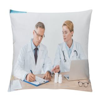 Personality  Attractive Doctor Pointing With Finger Near Laptop And Coworker In Glasses Writing Diagnosis  Pillow Covers