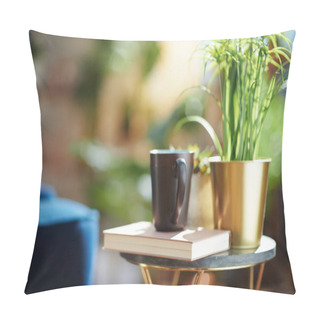 Personality  Green Home. Closeup On Book, Cup, And Potted Plant On Small Table At Modern Home In Sunny Day. Pillow Covers
