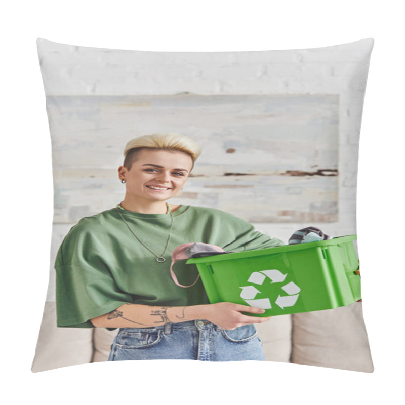 Personality  overjoyed tattooed woman with trendy hairstyle standing with garments in green recycling box and looking at camera at home, sustainable living and environmentally friendly habits concept pillow covers