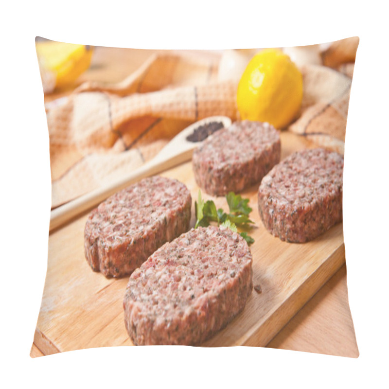 Personality  Raw burgers on a cutting board with lemon wedges pillow covers