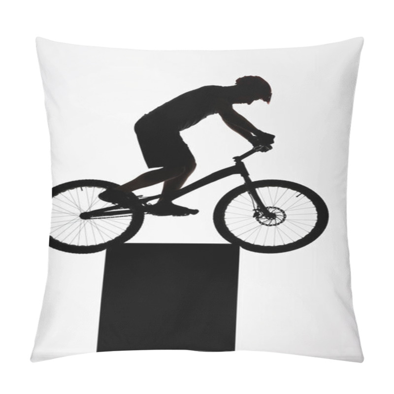 Personality  silhouette of trial cyclist balancing on stand on white pillow covers