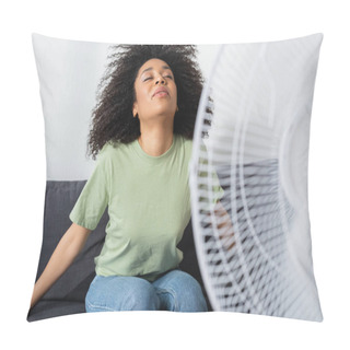 Personality  Curly African American Woman Sitting On Couch Near Blurred Electric Fan Pillow Covers