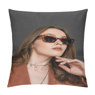 Personality  Portrait Of Stylish Young Woman With Long Hair Wearing Suit With Terracotta Blazer And Posing In Trendy Sunglasses While Looking Away Near Blurred Armchair On Grey Background, Fashionable Model  Pillow Covers