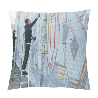 Personality  Street Artists Standing On Ladders And Painting Colorful Graffiti On Building Pillow Covers