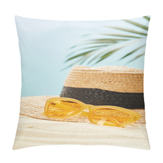 Personality  Selective Focus Of Yellow Sunglasses Near Straw Hat On Golden Sand In Summertime Isolated On Blue Pillow Covers
