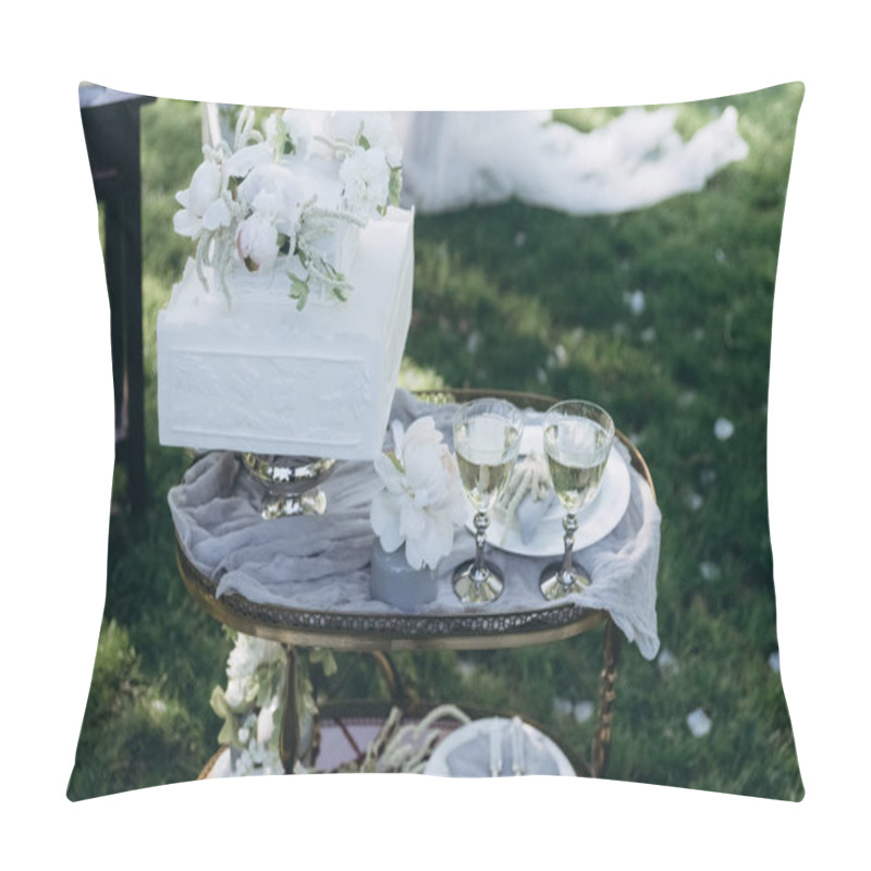 Personality  table with wedding cake and glasses of champagne on green grass pillow covers