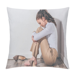 Personality  Sad Woman In White Blouse And Beige Pants Sitting On Floor With Head Bent Near White Wall At Home, Grieving Disorder Concept Pillow Covers