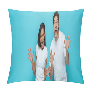 Personality  Panoramic Shot Of Cheerful Interracial Couple Showing Frightening Gestures At Camera On Blue Background Pillow Covers