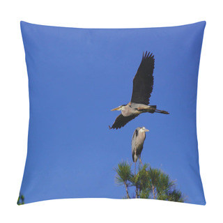 Personality  A Great Blue Heron Flies By Another One That Is Perched On The Top Of A Tree. Pillow Covers