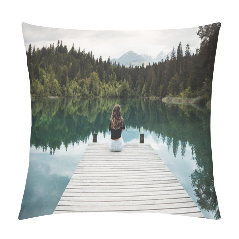 Personality  The girl turned her back looks into the crystal clear water in the lake pillow covers