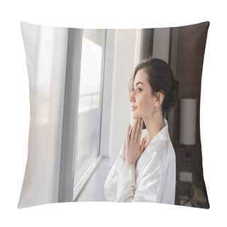 Personality  Side View Of Hopeful Young Woman With Engagement Ring On Finger Standing In White Silk Robe With Praying Hands And Looking Through Window In Hotel Suite, Special Occasion, Bride On Wedding Day Pillow Covers