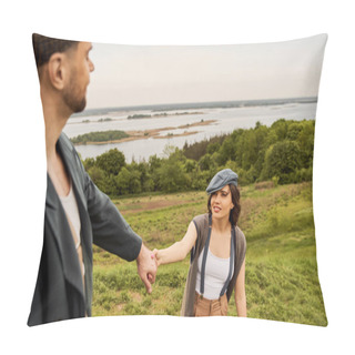 Personality  Smiling And Trendy Brunette Woman In Suspenders And Newsboy Cap Holding Hand Of Blurred Boyfriend In Jacket While Standing With Nature And Sky At Background, Fashionable Couple In Countryside Pillow Covers