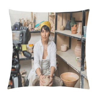 Personality  Young Brunette Asian Craftswoman In Headscarf And Workwear Molding Clay On Pottery Wheel Near Blurred Digital Camera On Tripod And Rack With Sculptures In Studio, Pottery Artist Showcasing Craft Pillow Covers