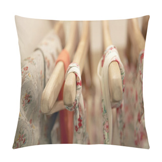 Personality  Detail Of Floral Clothes Hanging On Wooden Hangers In A Fashion Store. Pillow Covers