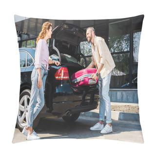 Personality  Low Angle View Of Happy Man Putting Pink Luggage In Car Trunk Near Woman  Pillow Covers