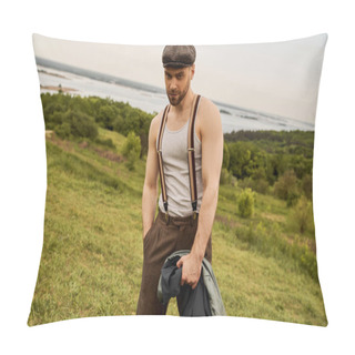 Personality  Stylish Bearded Man In Newsboy Cap And Suspenders Holding Hand In Pocket Of Pants And Jacket While Looking At Camera And Standing With Landscape At Background, Fashion-forward In Countryside Pillow Covers