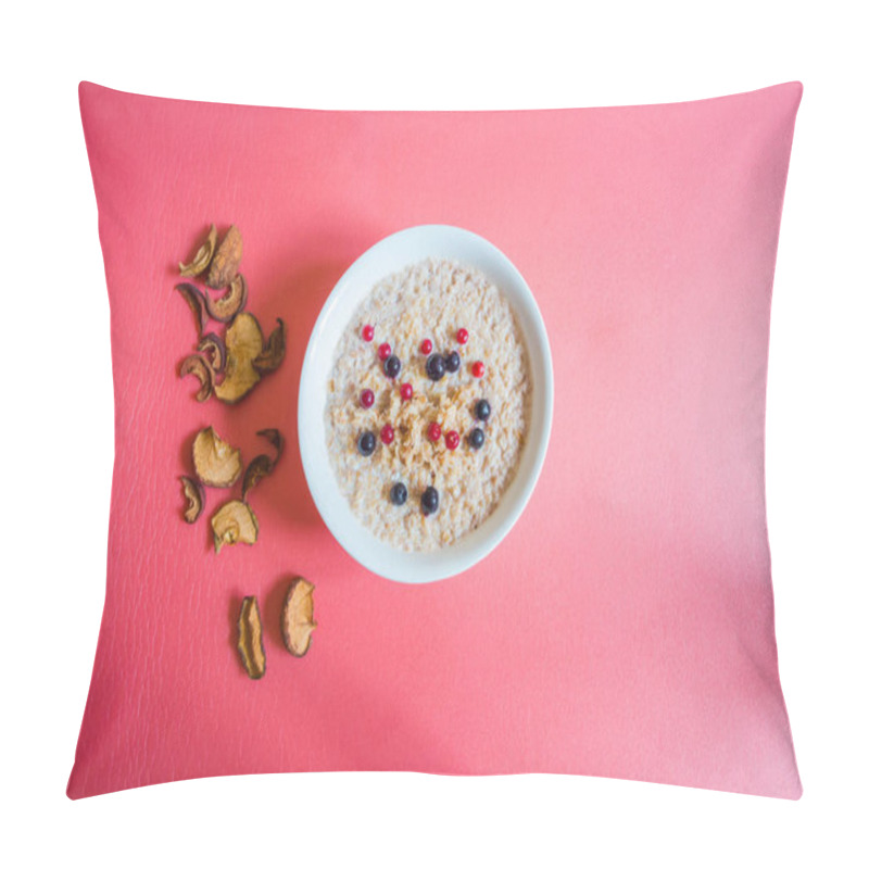 Personality  Tasty buckwheat porridge with milk and berries. Next to the plate are dried fruits from apples and pears. A plate and dried fruits on a neutral background of pink hue. pillow covers