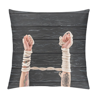 Personality  Cropped Shot Of Female Tattooed Hands Tied In Rope On Dark Wooden Tabletop Pillow Covers